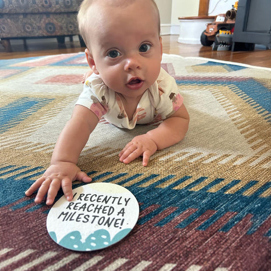 Baby with a milestone card